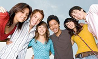 A group of teens broadly smiling